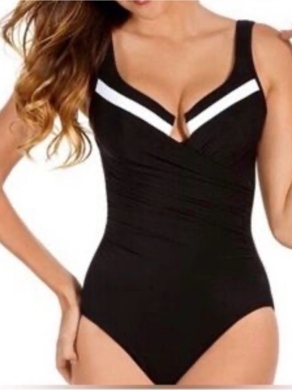 Women’s black one piece swimsuit with white accents. Built in tummy control .